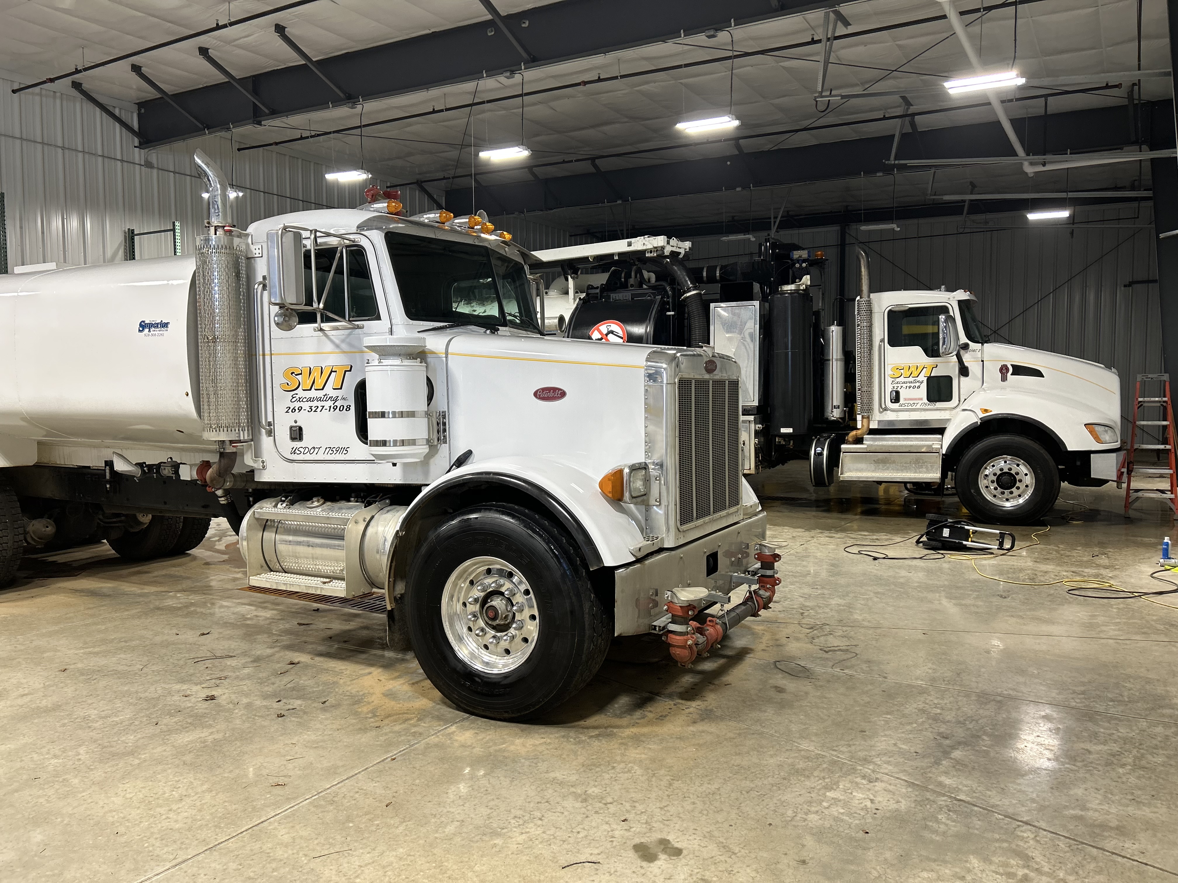 SWT Excavating semi trucks detailed inside the shop